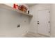 Bright laundry room with washer/dryer hookups and shelving at 4584 E Chisum Trl, Phoenix, AZ 85050