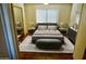Warm bedroom with ample natural light showcasing neutral decor, sleek furniture, and wood flooring at 4901 S Calle Los Cerros Dr # 202, Tempe, AZ 85282