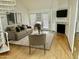 Airy living room featuring fireplace, white trim, neutral walls, and access to white spiral staircase at 4901 S Calle Los Cerros Dr # 202, Tempe, AZ 85282