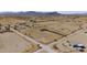 Aerial view of mobile home on a large lot in a rural desert area with mountain views at 53275 W Adele Rd, Maricopa, AZ 85139