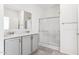 Modern bathroom with gray double vanity, tiled floors, and a shower at 53275 W Adele Rd, Maricopa, AZ 85139