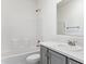 Clean bathroom with gray vanity, shower/tub, and white tile at 53275 W Adele Rd, Maricopa, AZ 85139