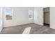 Well-lit bedroom featuring two windows and a closet at 53275 W Adele Rd, Maricopa, AZ 85139