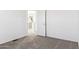 Simple bedroom with neutral walls, carpet and view of kitchen at 53275 W Adele Rd, Maricopa, AZ 85139