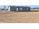 Gray manufactured home with large lot in desert setting at 53275 W Adele Rd, Maricopa, AZ 85139
