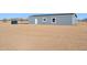 Gray house on a large lot with desert landscape at 53275 W Adele Rd, Maricopa, AZ 85139