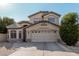 Two-story house with a three-car garage and neatly landscaped yard at 553 E Kyle Ct, Gilbert, AZ 85296