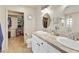 Bathroom featuring double sinks, ample counter space, and an open closet at 5951 E Trailridge St, Mesa, AZ 85215