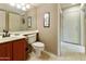 Cozy bathroom featuring a red vanity, ceramic toilet, and a large mirror at 5951 E Trailridge St, Mesa, AZ 85215