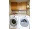 Laundry room featuring a side-by-side washer and dryer and upper cabinet storage at 5951 E Trailridge St, Mesa, AZ 85215