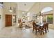 Open living and dining area features travertine floors, vaulted ceilings and lots of natural light at 5951 E Trailridge St, Mesa, AZ 85215