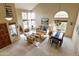 Bright living room features vaulted ceilings, travertine floors, multiple windows, and dining area at 5951 E Trailridge St, Mesa, AZ 85215