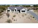 Beautiful modern home showcasing desert landscaping, a paver driveway, and a neutral color palette at 8714 E Tether Trl, Scottsdale, AZ 85255