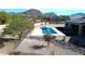 Backyard featuring a modern pool, spa, artificial turf, desert landscaping and views of nearby mountains at 8714 E Tether Trl, Scottsdale, AZ 85255