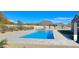 Inviting backyard with a sparkling blue pool and spa, set against a serene mountain backdrop at 8714 E Tether Trl, Scottsdale, AZ 85255