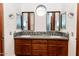 Double vanity bathroom with wood cabinets and gray counters at 100 W Sparrow Dr, Chandler, AZ 85286