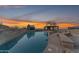 Relaxing pool area with stone patio and pergola, offering stunning sunset views at 11403 S 27Th Dr, Laveen, AZ 85339