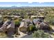 Aerial view of the house and surrounding neighborhood with mountain views at 11714 N 134Th St, Scottsdale, AZ 85259