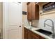 Laundry room with utility sink and ample cabinet space at 11714 N 134Th St, Scottsdale, AZ 85259