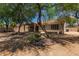 View of a beautiful backyard with desert landscaping and a covered patio area at 1231 W Hawken Way, Chandler, AZ 85286
