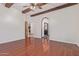 Spacious bedroom featuring a ceiling fan, wood floors, and arched doorways at 1231 W Hawken Way, Chandler, AZ 85286