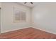 Bedroom featuring wood floors and a window with wood shutters at 1231 W Hawken Way, Chandler, AZ 85286