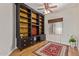Bedroom featuring a large built-in bookshelf, a ceiling fan, and a decorative rug at 1231 W Hawken Way, Chandler, AZ 85286