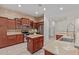 Kitchen featuring wood cabinets, stainless steel appliances, and a center island at 1231 W Hawken Way, Chandler, AZ 85286