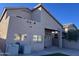 Two-story house back, highlighting the patio, landscaping, and AC units at 15091 N 90Th Dr, Peoria, AZ 85381