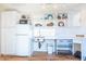 Small kitchenette with white cabinets, refrigerator, and sink at 17808 N Navarro Ct, Surprise, AZ 85374
