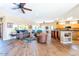 Spacious living room with hardwood floors, leather furniture, and a view into the kitchen at 17808 N Navarro Ct, Surprise, AZ 85374