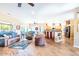 Open living room and kitchen with hardwood floors, island, and leather furniture at 17808 N Navarro Ct, Surprise, AZ 85374
