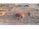 An aerial view features new construction homes in a desert landscape with freshly graded lots and mountain views at 21165 W Carver Rd, Buckeye, AZ 85326