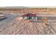 Aerial view of desert home with red tile roof and white stucco exterior at 21165 W Carver Rd, Buckeye, AZ 85326