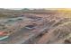 Aerial view of a new construction development featuring desert homes, freshly graded lots, and mountain views at 21165 W Carver Rd, Buckeye, AZ 85326