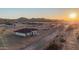 Sunset view of a desert landscape with new homes and mountain views in the distance at 21165 W Carver Rd, Buckeye, AZ 85326