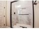 Modern bathroom shower stall with a glass door and tile surround at 21165 W Carver Rd, Buckeye, AZ 85326