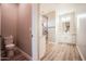 Contemporary bathroom features marble countertops, white cabinets, sleek fixtures, and a glass-enclosed shower at 21165 W Carver Rd, Buckeye, AZ 85326
