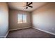 Bedroom with neutral carpet, ceiling fan, and window view at 21165 W Carver Rd, Buckeye, AZ 85326