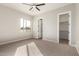 Well-lit bedroom with carpet, ceiling fan and closet at 21165 W Carver Rd, Buckeye, AZ 85326