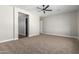 Spacious bedroom with ceiling fan and carpeted floors at 21165 W Carver Rd, Buckeye, AZ 85326