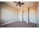 Bedroom featuring a ceiling fan, closet, and neutral carpet at 21165 W Carver Rd, Buckeye, AZ 85326