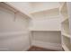 Walk-in closet with white shelving and rods providing ample storage space and organization at 21165 W Carver Rd, Buckeye, AZ 85326