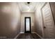 Elegant entryway features decorative iron door, tray ceiling, and modern lighting at 21165 W Carver Rd, Buckeye, AZ 85326
