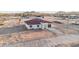 New construction shows a tan house with a red tile roof against the backdrop of distant mountains and open desert at 21165 W Carver Rd, Buckeye, AZ 85326