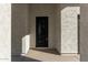 Elegant front entry with black metal door at 21165 W Carver Rd, Buckeye, AZ 85326