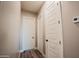 Hallway featuring hardwood floors and modern white doors at 21165 W Carver Rd, Buckeye, AZ 85326