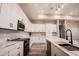 Modern kitchen boasts white cabinetry, marble countertops, and stainless steel appliances at 21165 W Carver Rd, Buckeye, AZ 85326