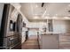 Modern kitchen features stainless steel appliances, white cabinets, marble countertops, and a stylish island at 21165 W Carver Rd, Buckeye, AZ 85326