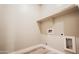Empty laundry room with wood-look flooring, utility connections, and overhead shelving at 21165 W Carver Rd, Buckeye, AZ 85326
